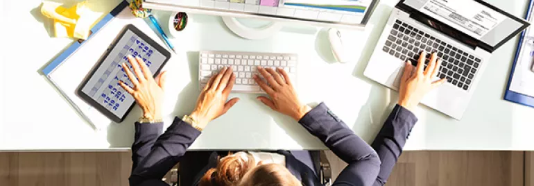 woman with 4 arms using three computers simultaneously