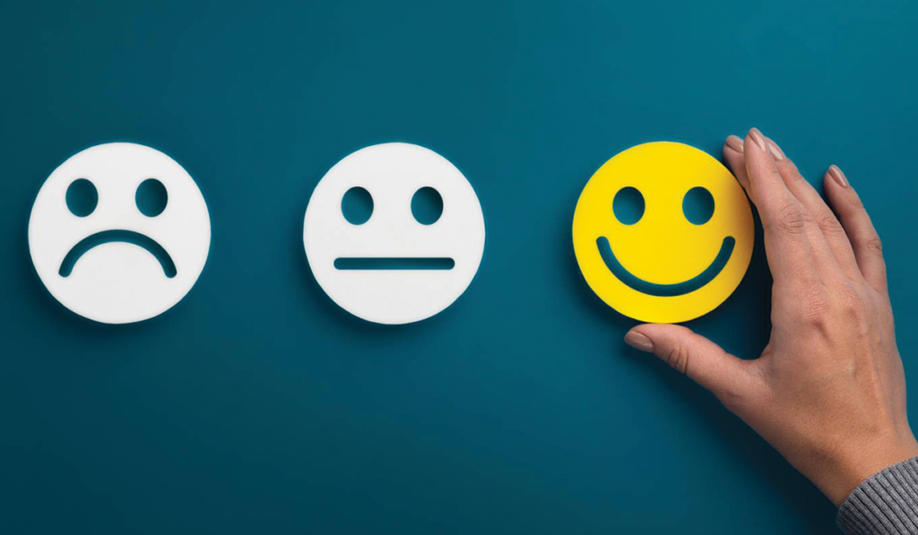 image of hand selecting a smiley face