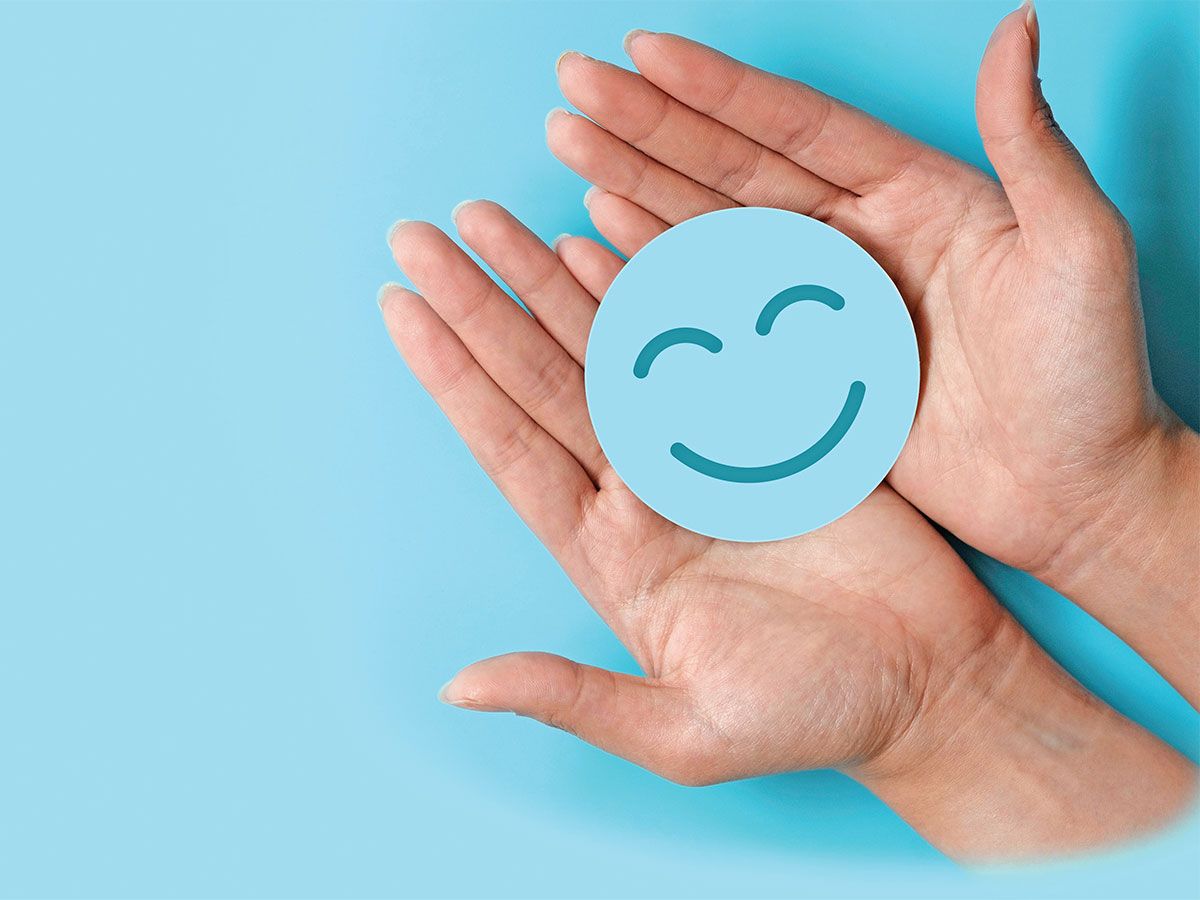 photo of hands holding a smiley face