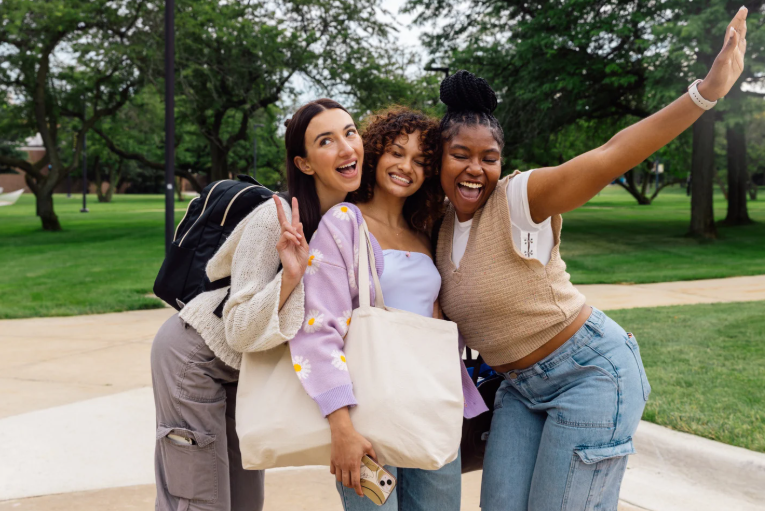 three happy female college students